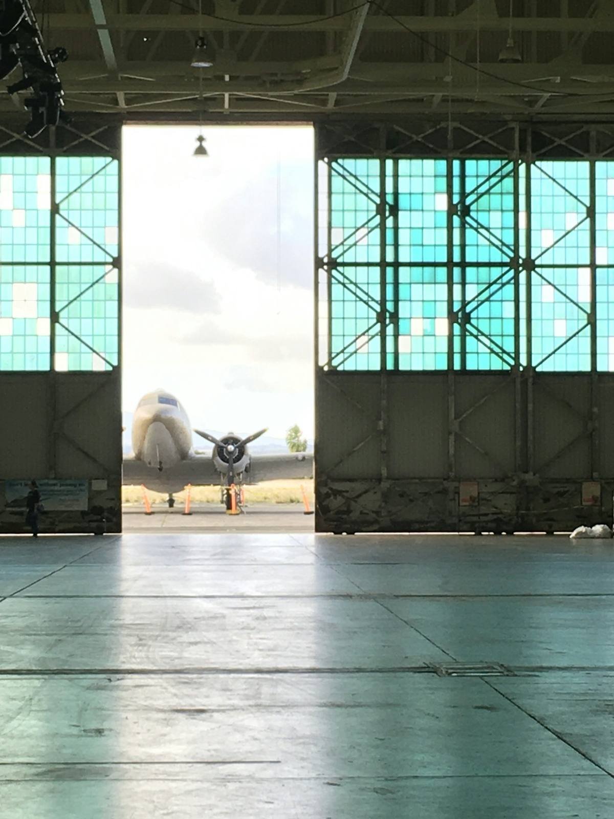 Aircraft parked in an open hangar