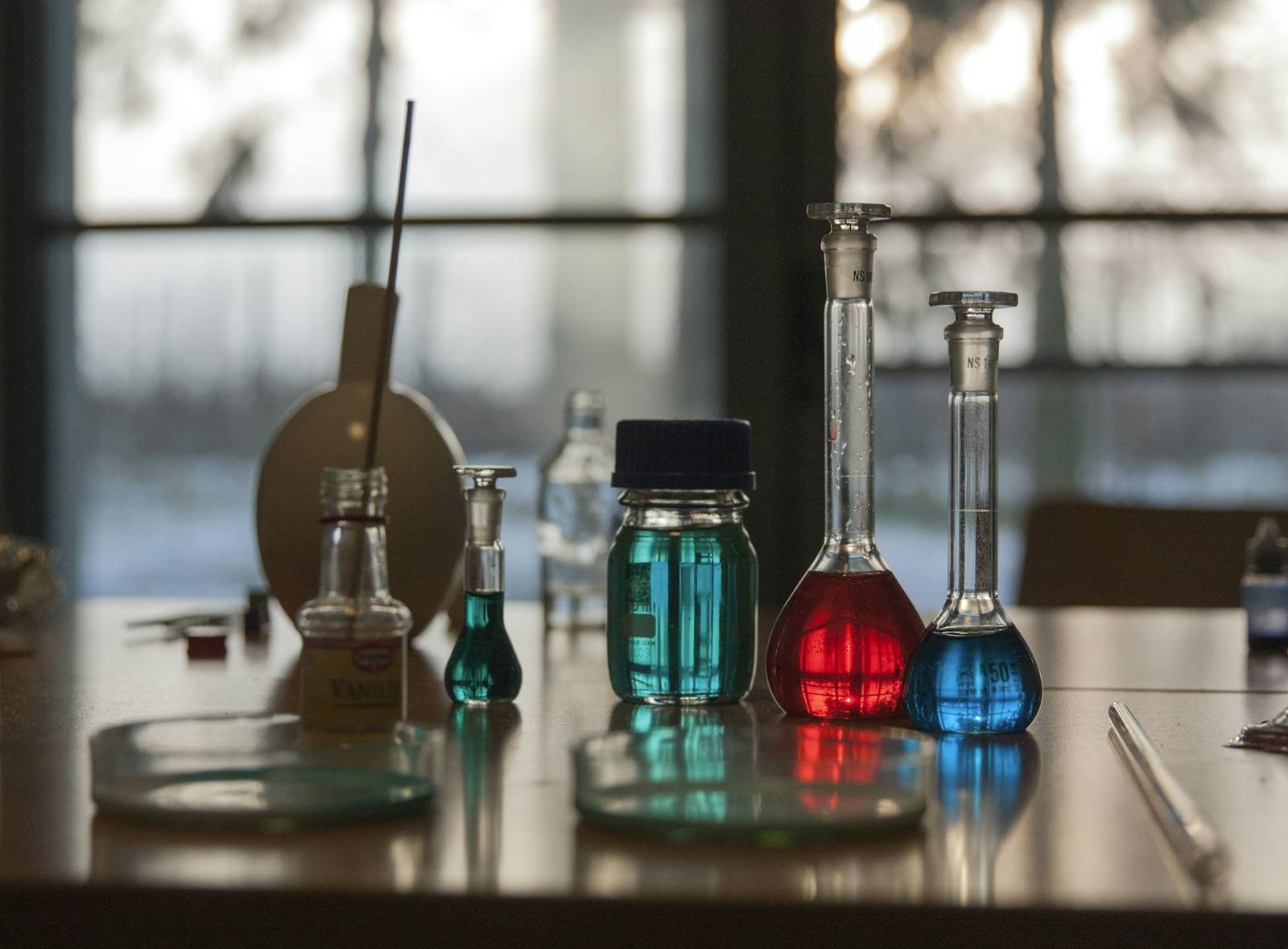 Laboratory flasks filled with coloured chemical solutions