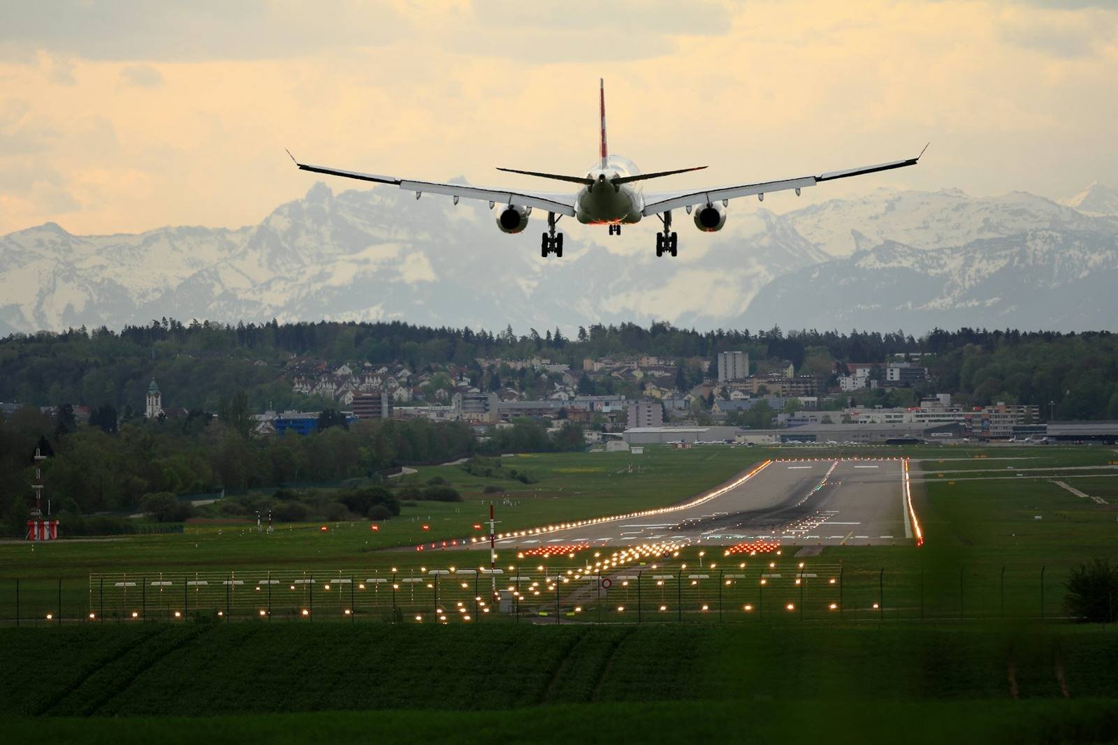 Airliner landing over runway approach lights