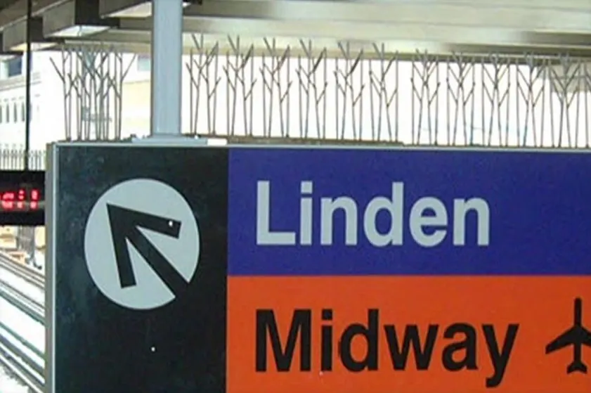 Stainless steel bird spikes on top of an airport sign