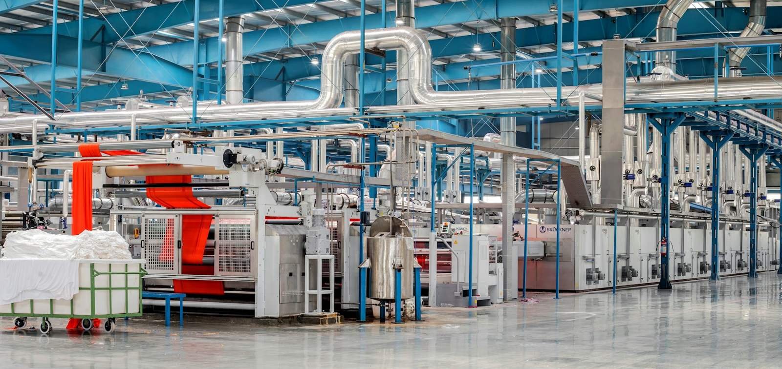 Modern textile processing machinery in a factory hall